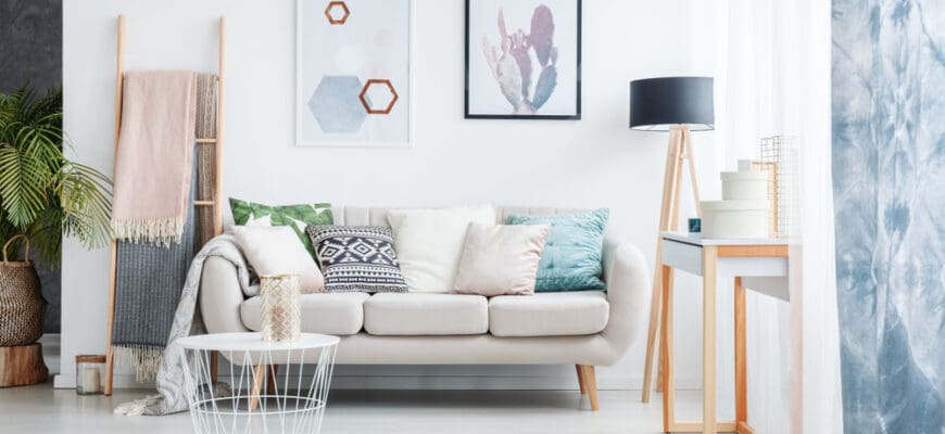 Paintings,Of,Cactus,And,Hexagons,Hanging,Over,A,Cozy,Sofa