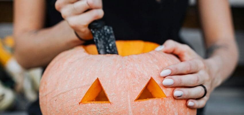 Woman carving pumpkin